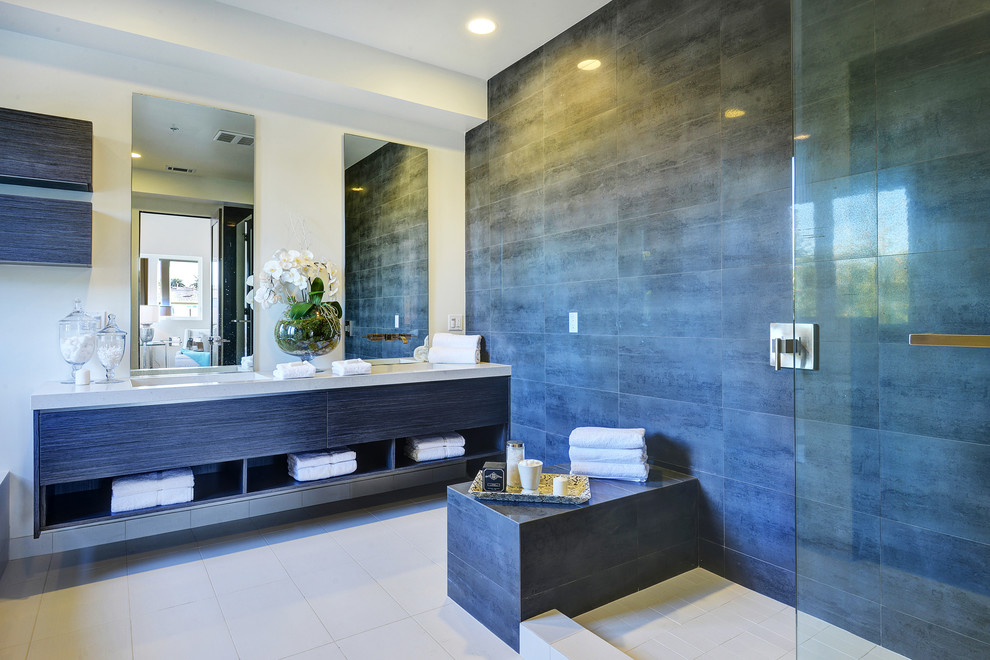 This is an example of a contemporary bathroom in Los Angeles with flat-panel cabinets, an open shower, gray tile, beige walls and an open shower.