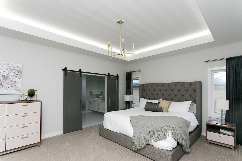 Mid-sized modern master bedroom with white walls, carpet and grey floor.