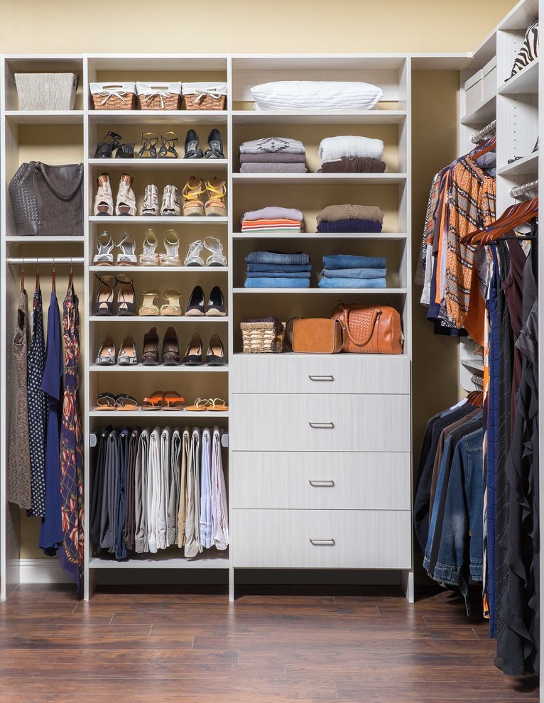 Design ideas for a mid-sized transitional women's built-in wardrobe in Denver with flat-panel cabinets, white cabinets and dark hardwood floors.