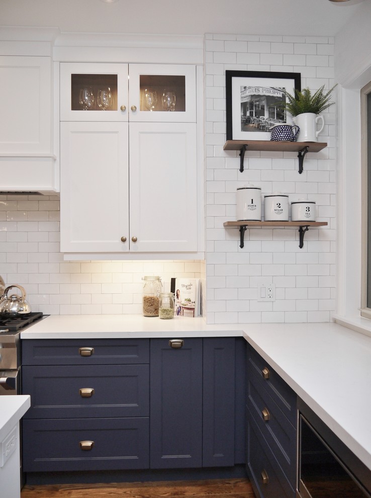 Eat-in kitchen - mid-sized transitional l-shaped medium tone wood floor and brown floor eat-in kitchen idea in Toronto with an undermount sink, shaker cabinets, blue cabinets, quartz countertops, white backsplash, subway tile backsplash, stainless steel appliances, an island and white countertops