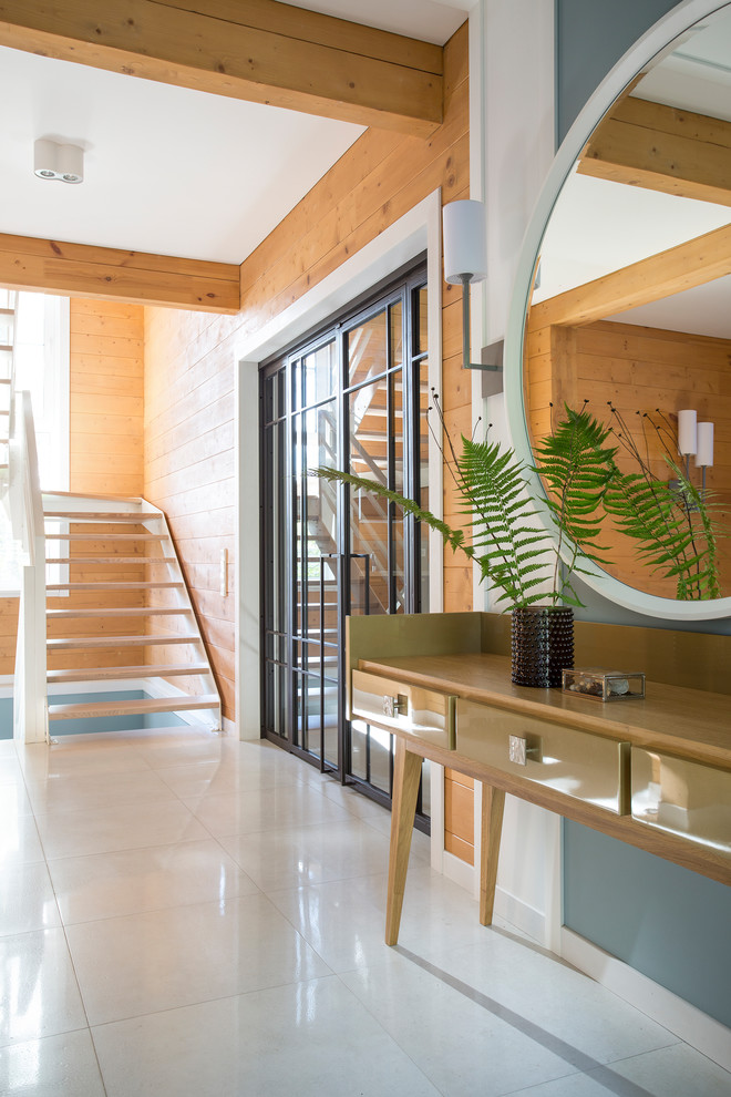 Photo of a contemporary entry hall in Moscow with brown walls and white floor.