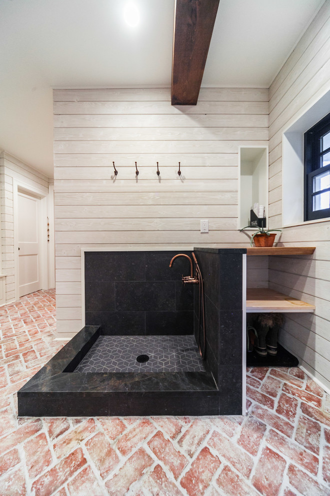 This is an example of a large country bathroom in Philadelphia with white walls, brick floors and multi-coloured floor.