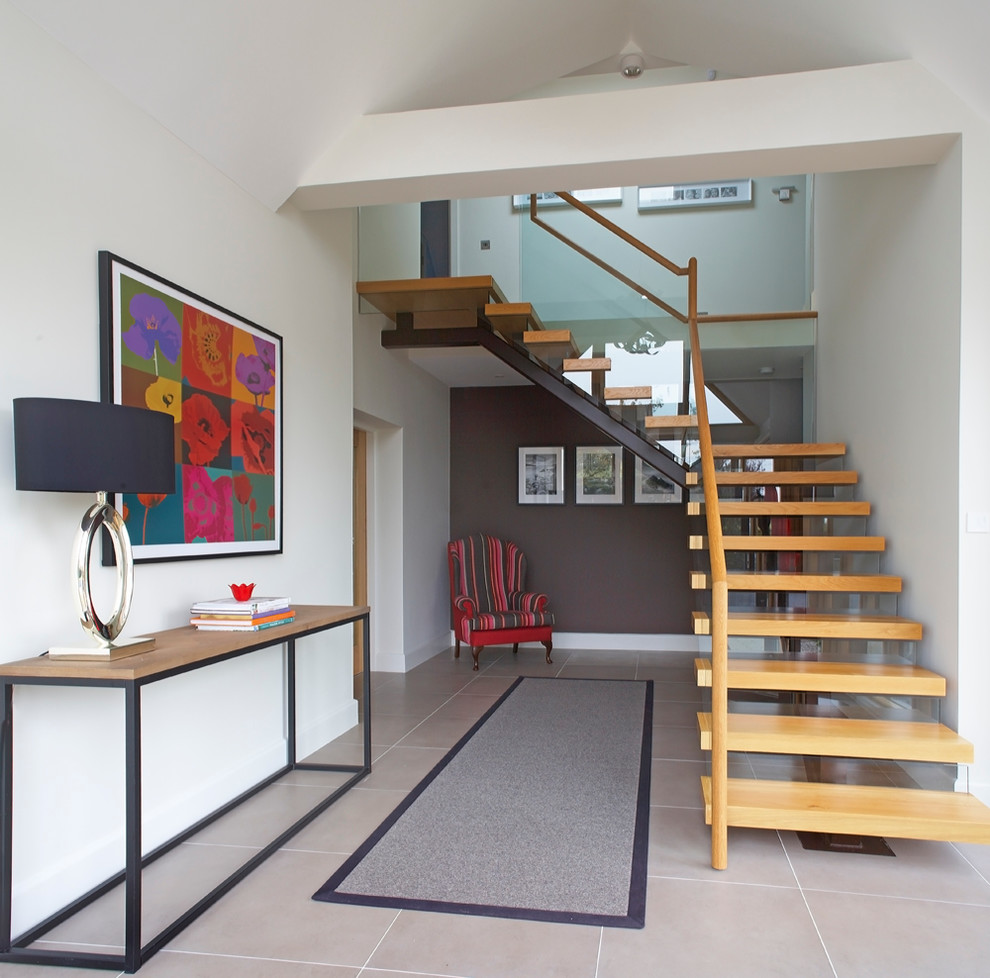 Design ideas for a contemporary entryway in Dublin with white walls.
