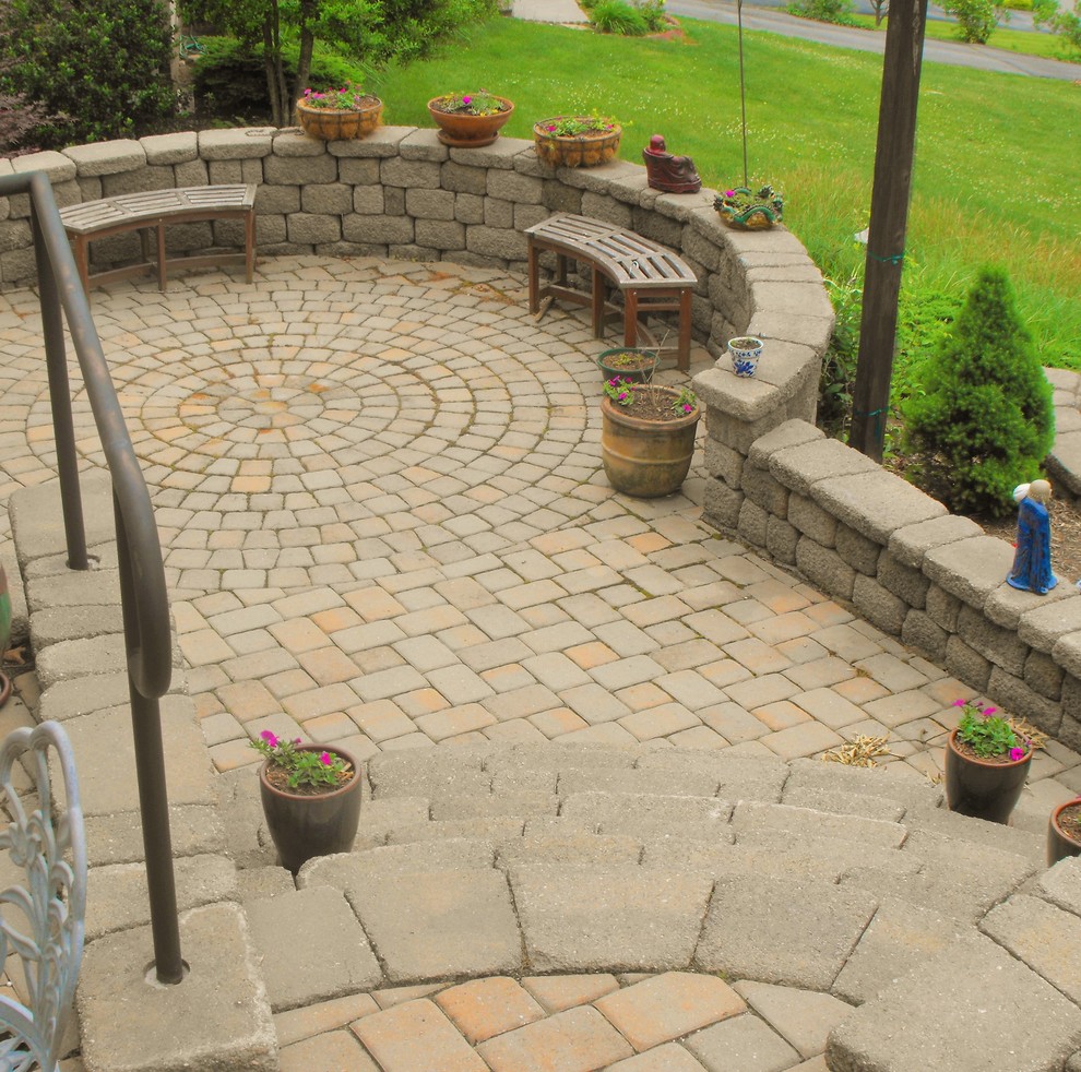 This is an example of a mid-sized asian front yard patio in Other with concrete pavers.