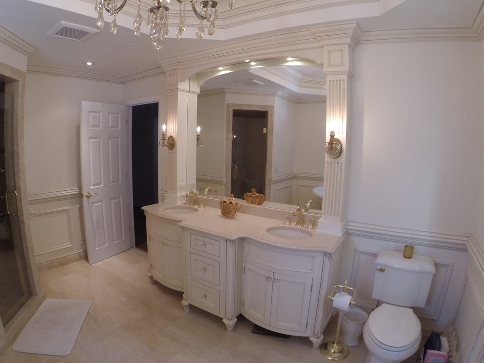 Design ideas for a mid-sized traditional master bathroom in New York with shaker cabinets, yellow cabinets, a freestanding tub, a two-piece toilet, white walls, porcelain floors, an undermount sink, engineered quartz benchtops and beige floor.