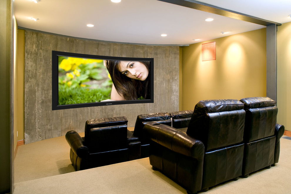 This is an example of a large contemporary enclosed home theatre in Los Angeles with yellow walls, carpet, a built-in media wall and beige floor.