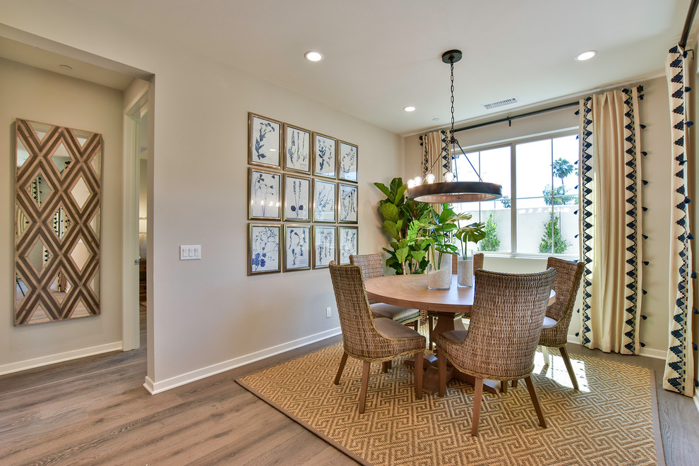 Beach style dining room in Orange County with beige walls, medium hardwood floors and brown floor.