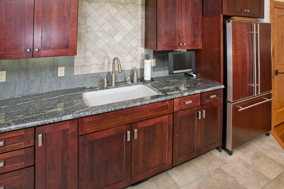 Open concept kitchen - large transitional l-shaped porcelain tile open concept kitchen idea in Denver with an undermount sink, shaker cabinets, red cabinets, granite countertops, gray backsplash, stone tile backsplash, black appliances and an island