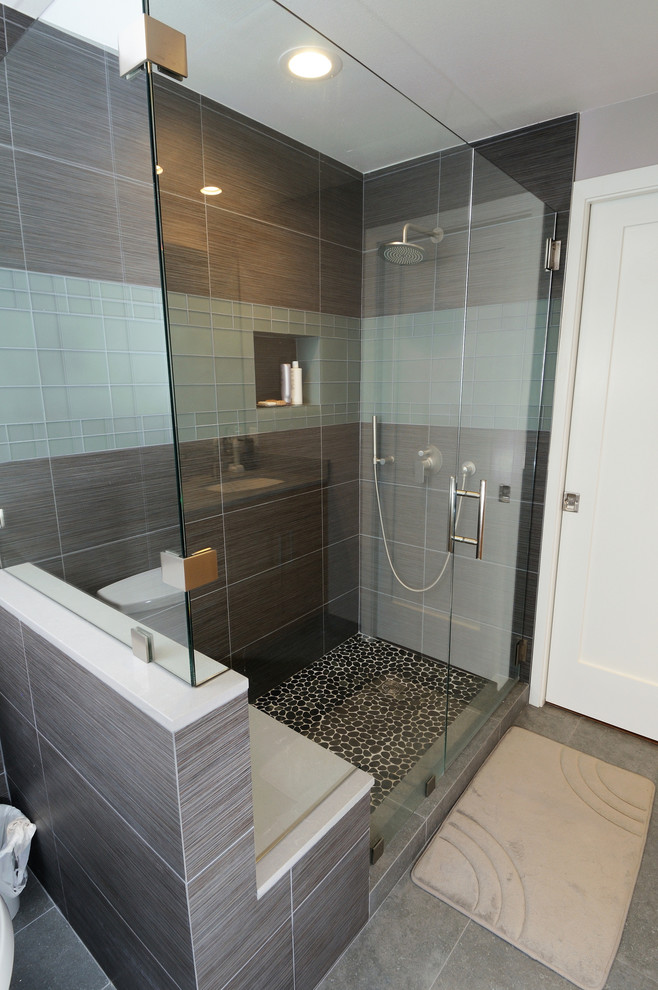 Mid-sized transitional master bathroom in Seattle with flat-panel cabinets, light wood cabinets, a corner tub, an open shower, a one-piece toilet, white tile, stone tile, pebble tile floors, a drop-in sink, soapstone benchtops, multi-coloured floor and an open shower.