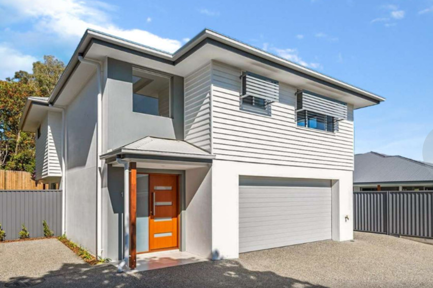 This is an example of a contemporary two-storey house exterior with a metal roof.