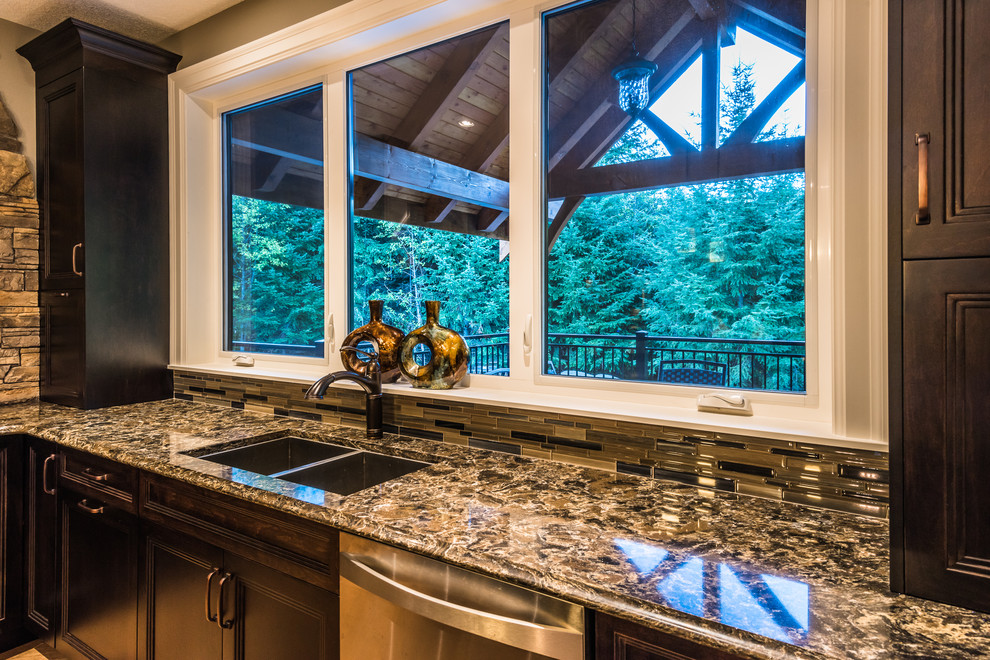 Mid-sized mountain style u-shaped medium tone wood floor eat-in kitchen photo with a drop-in sink, beaded inset cabinets, dark wood cabinets, granite countertops, multicolored backsplash, matchstick tile backsplash, stainless steel appliances and an island