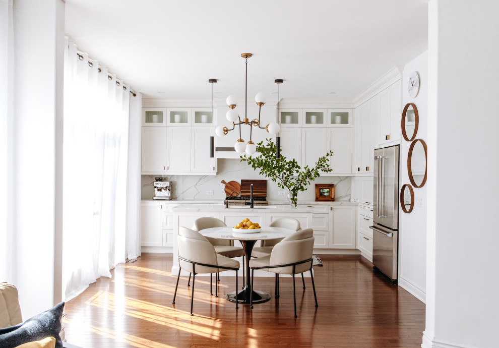Eat-in kitchen - mid-sized transitional l-shaped dark wood floor and brown floor eat-in kitchen idea in Toronto with an undermount sink, shaker cabinets, white cabinets, quartz countertops, white backsplash, quartz backsplash, black appliances, an island and white countertops