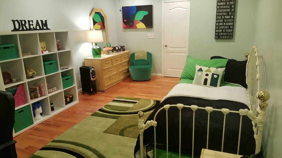 This is an example of a mid-sized transitional gender-neutral kids' room in Atlanta with green walls and medium hardwood floors.