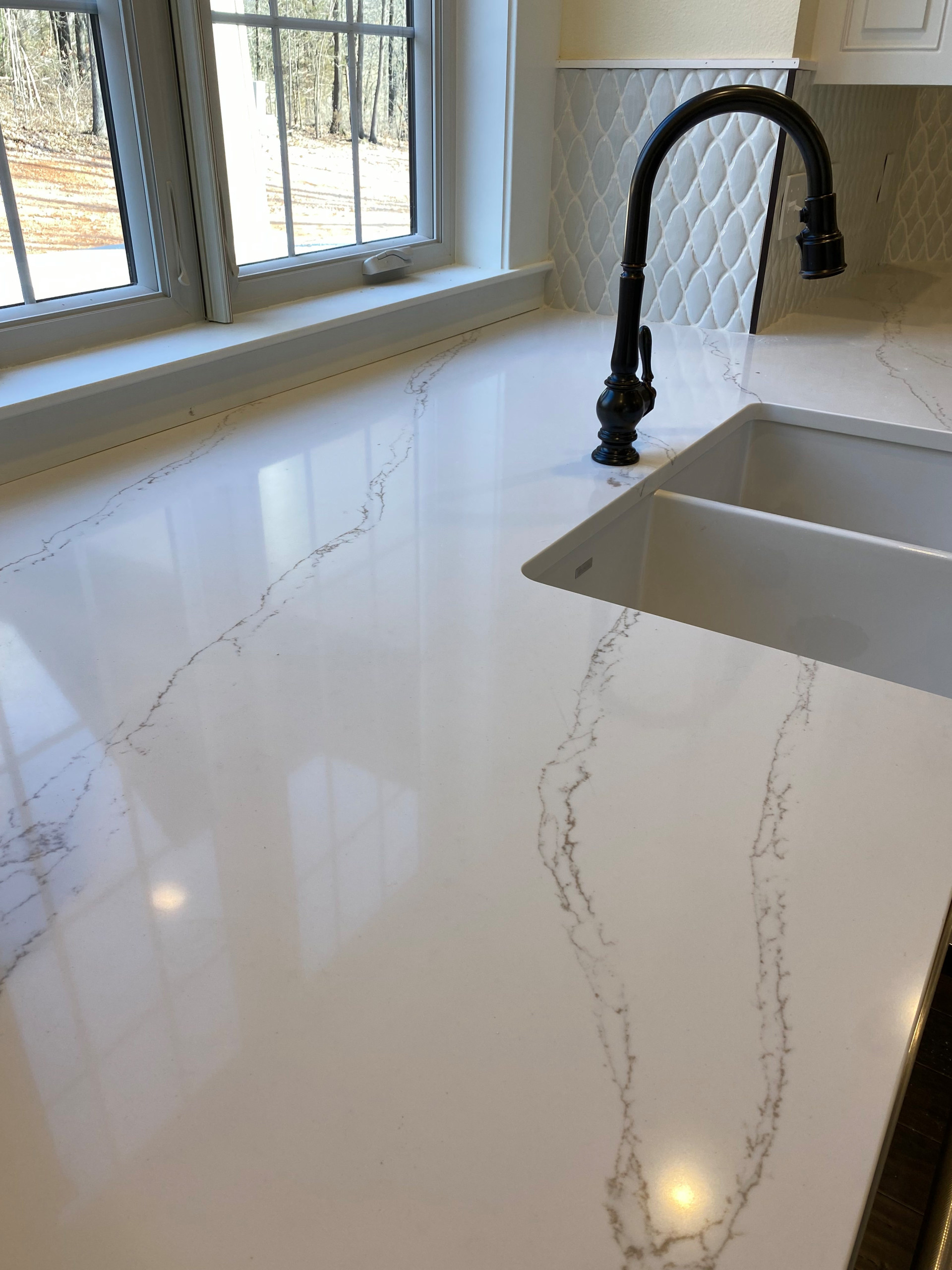 Kitchen quartz countertop and oil rubbed bronze pull down faucet