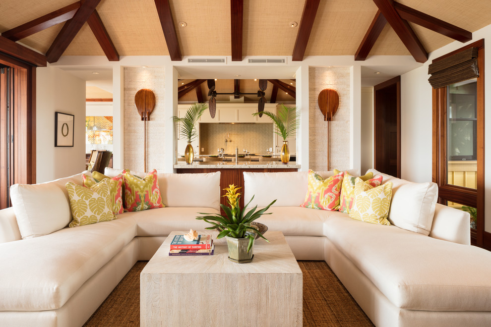 Mid-sized tropical open concept living room in Hawaii with white walls, medium hardwood floors, a built-in media wall and brown floor.