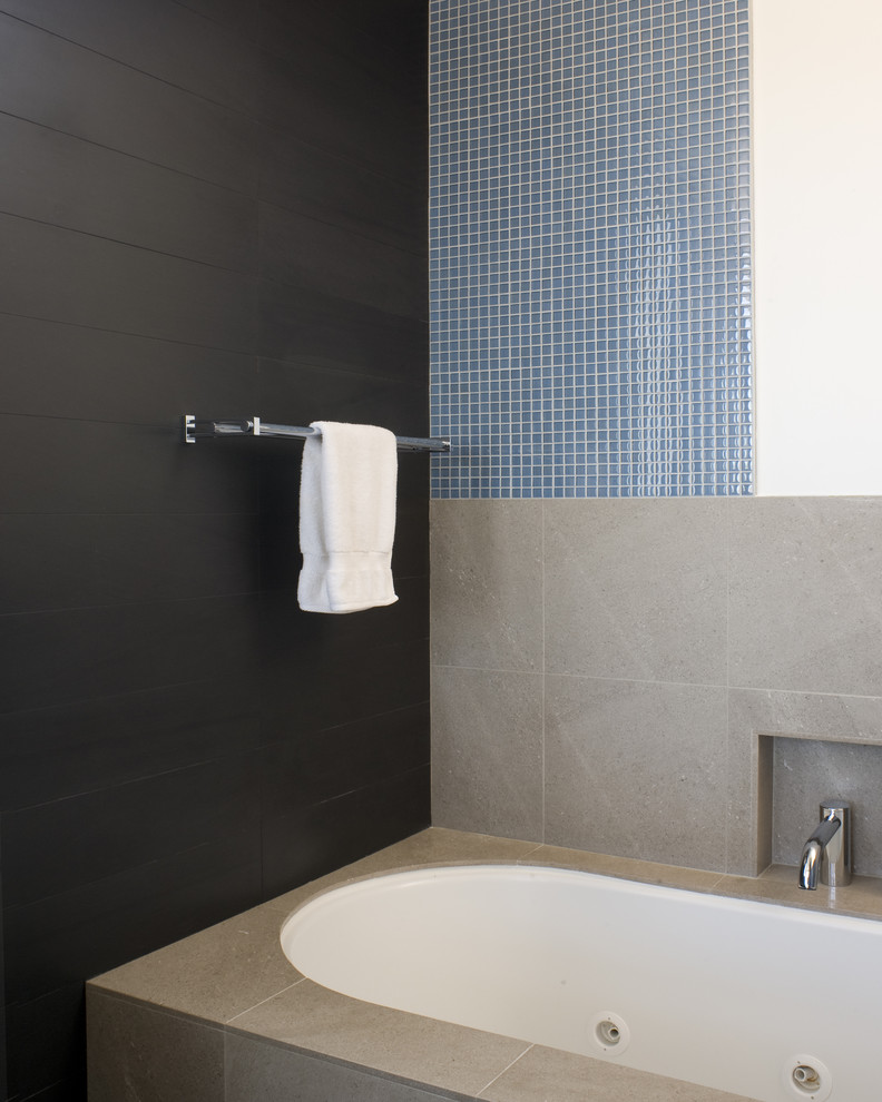 Inspiration for a modern bathroom in San Francisco with mosaic tile and black walls.