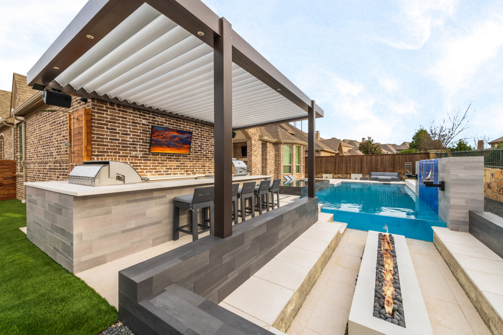 Large contemporary backyard rectangular pool in Dallas with a hot tub and natural stone pavers.