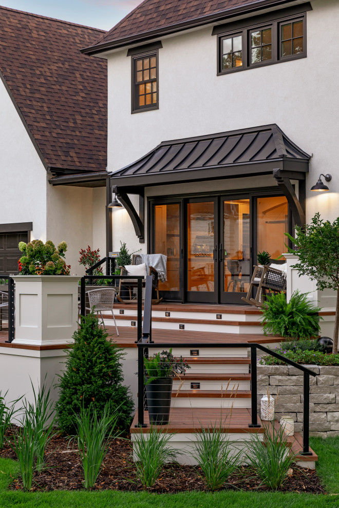 Inspiration pour une terrasse latérale et au rez-de-chaussée vintage de taille moyenne avec une extension de toiture et un garde-corps en câble.