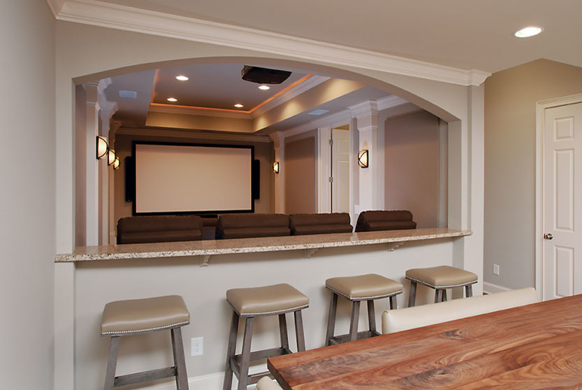 This is an example of a large contemporary open concept home theatre in Atlanta with grey walls, carpet and a projector screen.