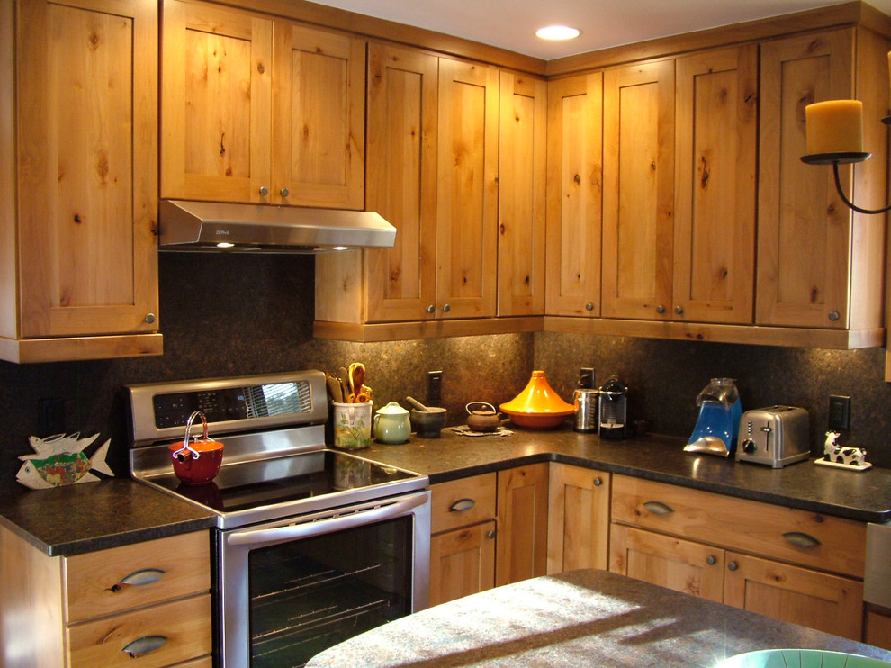 Photo of a large country galley separate kitchen in Denver with an integrated sink, flat-panel cabinets, medium wood cabinets, granite benchtops, brown splashback, stainless steel appliances and with island.
