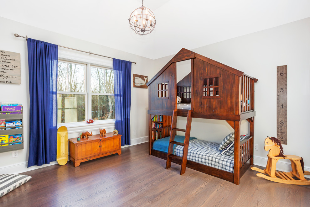 Transitional kids' bedroom in New York with grey walls, medium hardwood floors and brown floor for kids 4-10 years old and boys.
