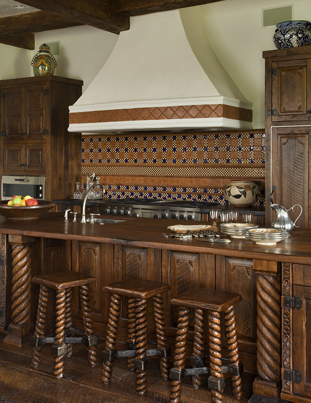 Eat-in kitchen - large rustic medium tone wood floor eat-in kitchen idea with raised-panel cabinets, wood countertops, mosaic tile backsplash, stainless steel appliances and an island