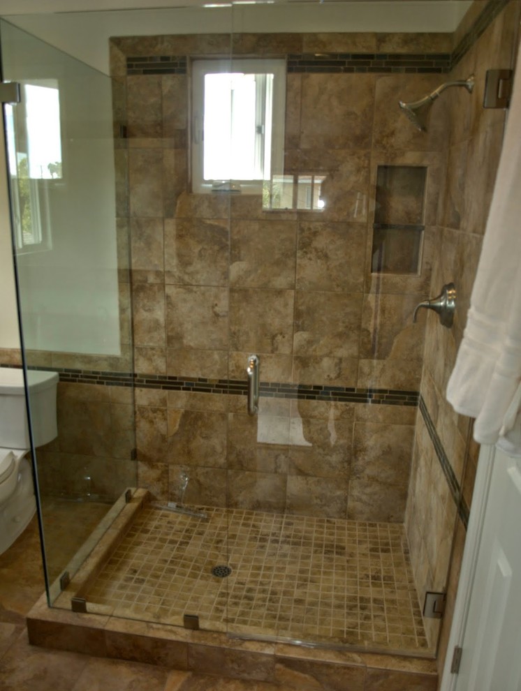 Inspiration for a mid-sized transitional 3/4 bathroom in Los Angeles with a corner shower, a two-piece toilet, brown tile, porcelain tile, white walls, porcelain floors, an integrated sink, glass benchtops, brown floor, a hinged shower door and green benchtops.