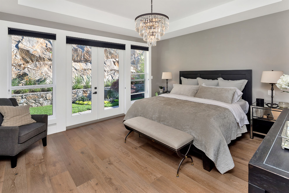 Example of a transitional medium tone wood floor and brown floor bedroom design