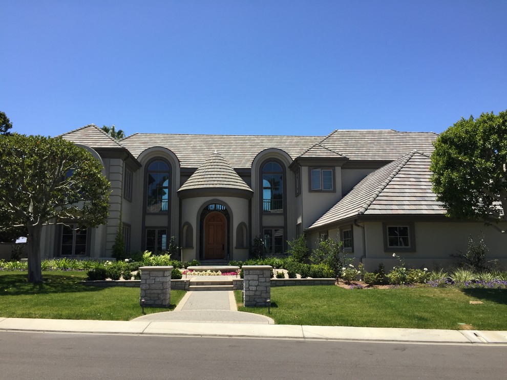 Expansive transitional two-storey stucco beige exterior in Orange County.
