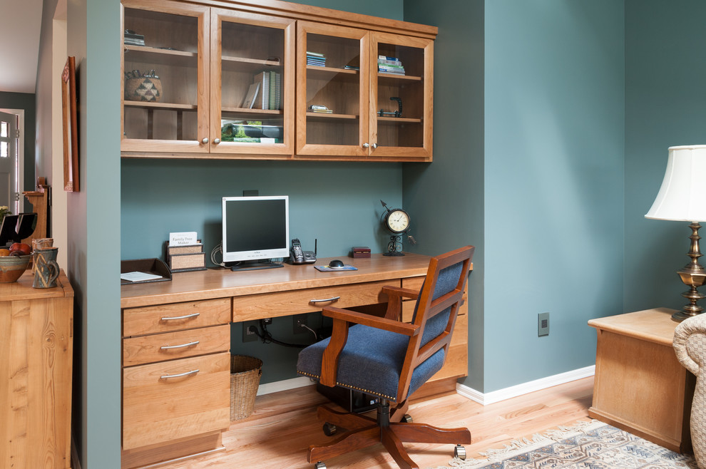 Inspiration for a small traditional home office in Seattle with light hardwood floors, no fireplace, a built-in desk and blue walls.