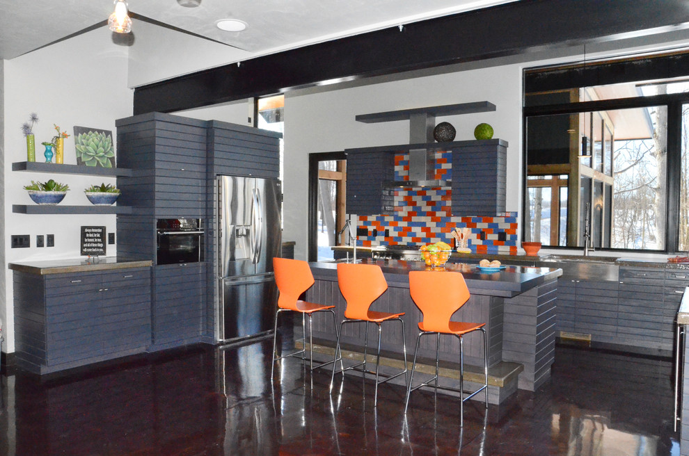 Eat-in kitchen - large contemporary l-shaped eat-in kitchen idea with louvered cabinets, gray cabinets, concrete countertops, orange backsplash, ceramic backsplash, stainless steel appliances and an island