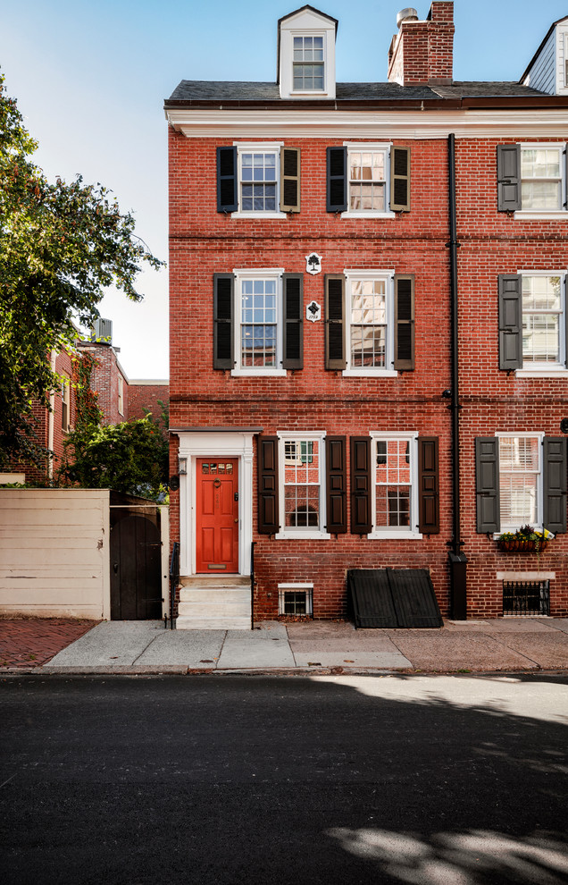 This is an example of a small transitional three-storey brick red exterior in Philadelphia.