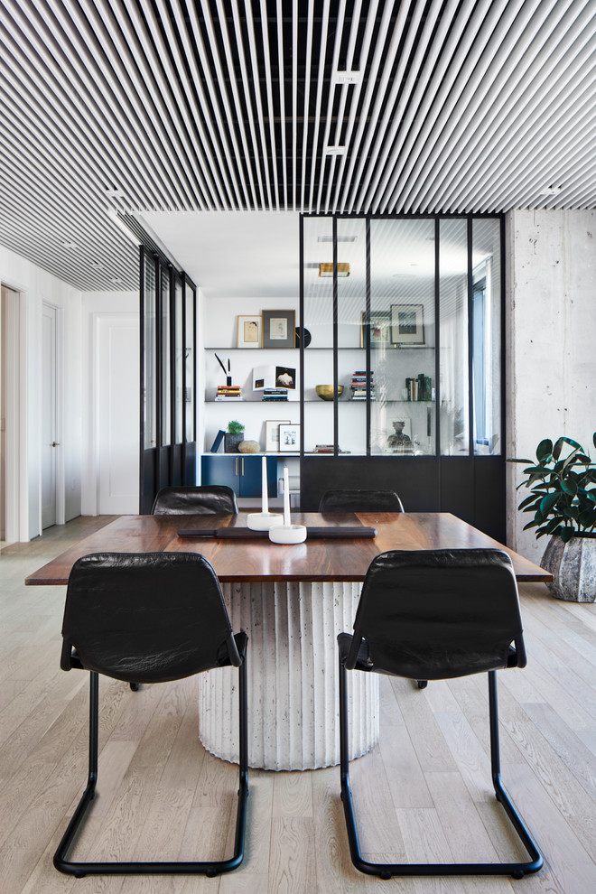 Inspiration for a contemporary light wood floor and beige floor dining room remodel in Austin with white walls