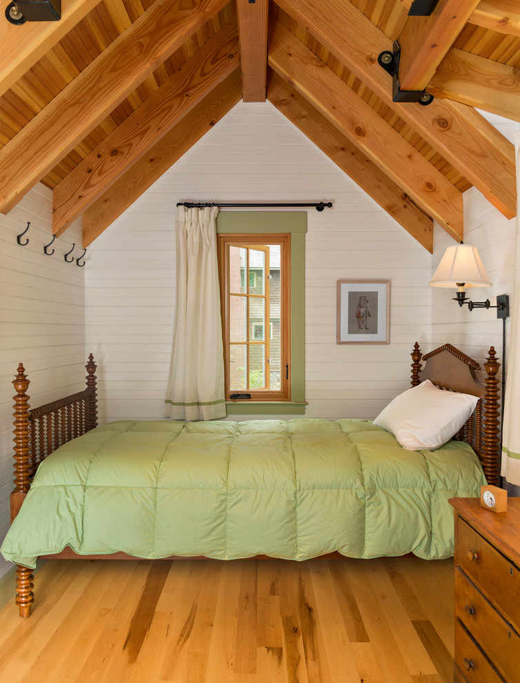 Bedroom - small rustic guest medium tone wood floor bedroom idea in Boston with white walls