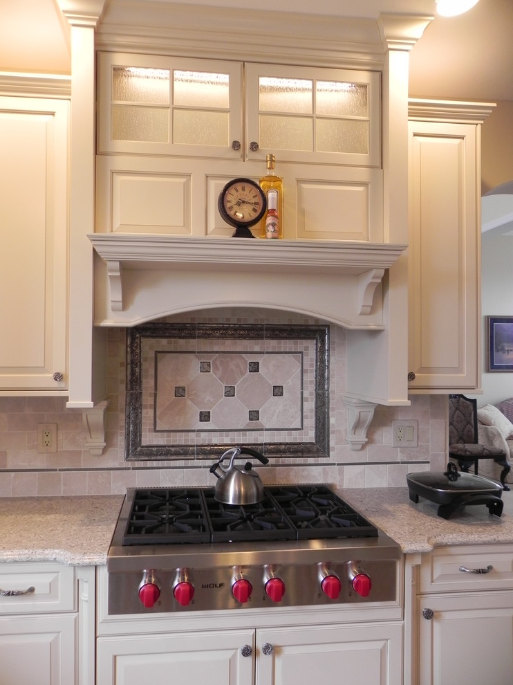 Example of a mid-sized transitional kitchen design with raised-panel cabinets, white cabinets, beige backsplash, subway tile backsplash and stainless steel appliances