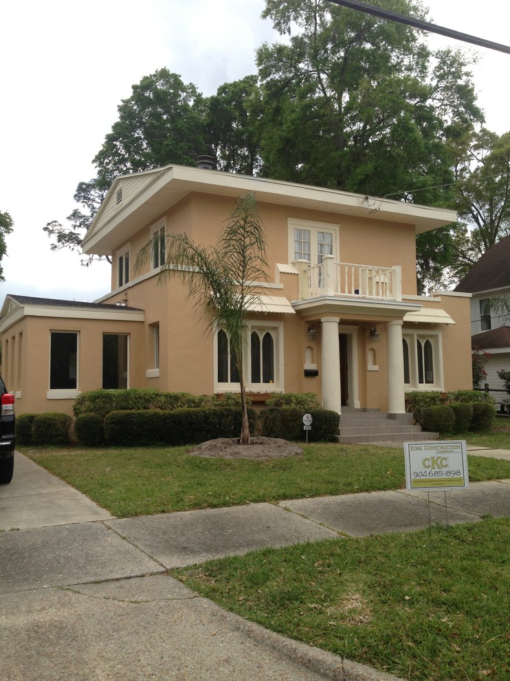 Photo of a mid-sized traditional two-storey stucco beige exterior in Jacksonville.