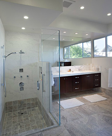 Inspiration for a mid-sized transitional master gray tile and marble tile gray floor and porcelain tile corner shower remodel with white walls, flat-panel cabinets, dark wood cabinets, a two-piece toilet, an undermount sink, quartz countertops and a hinged shower door