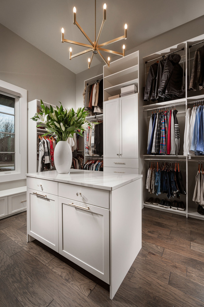 Inspiration for a large transitional gender-neutral walk-in wardrobe in Other with shaker cabinets, white cabinets, dark hardwood floors and brown floor.