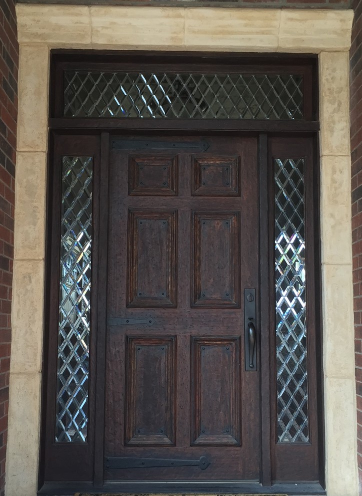 Example of a mid-sized mountain style brick floor home design design in Austin with beige walls and a dark wood front door