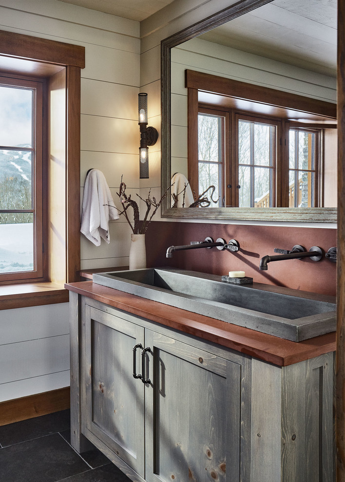 Country bathroom in Burlington with shaker cabinets, grey cabinets, white walls, a trough sink, grey floor and brown benchtops.