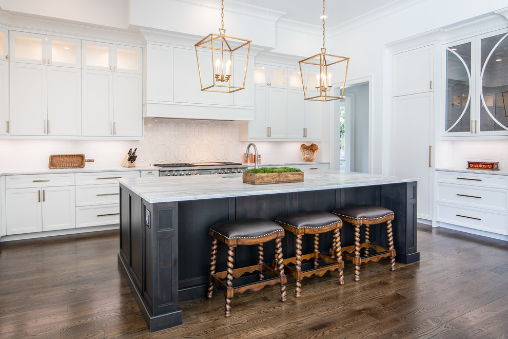 Design ideas for a large transitional u-shaped open plan kitchen in Charlotte with a double-bowl sink, white cabinets, quartzite benchtops, white splashback, ceramic splashback, panelled appliances, dark hardwood floors, with island, white benchtop and recessed-panel cabinets.