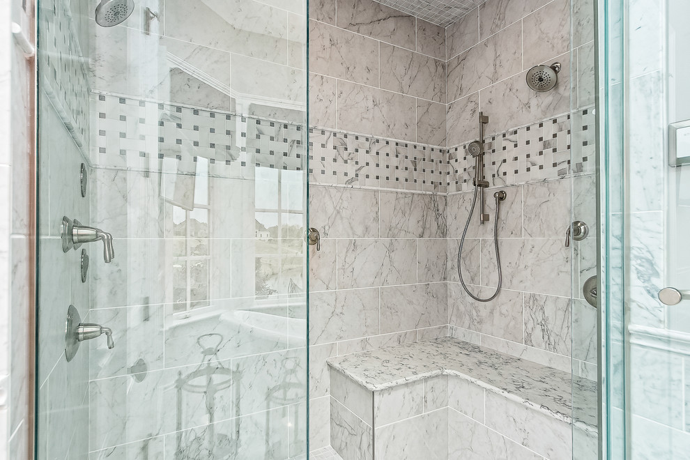 This is an example of a mid-sized transitional master bathroom in Columbus with an alcove shower, gray tile, marble and a hinged shower door.