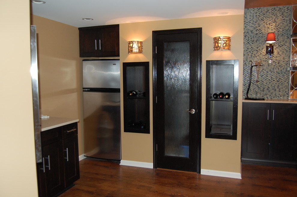 Large transitional underground medium tone wood floor home design photo in Chicago with yellow walls, a ribbon fireplace and a metal fireplace