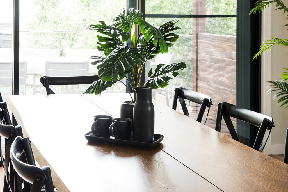 Design ideas for a large contemporary open plan dining in Sydney with white walls and medium hardwood floors.