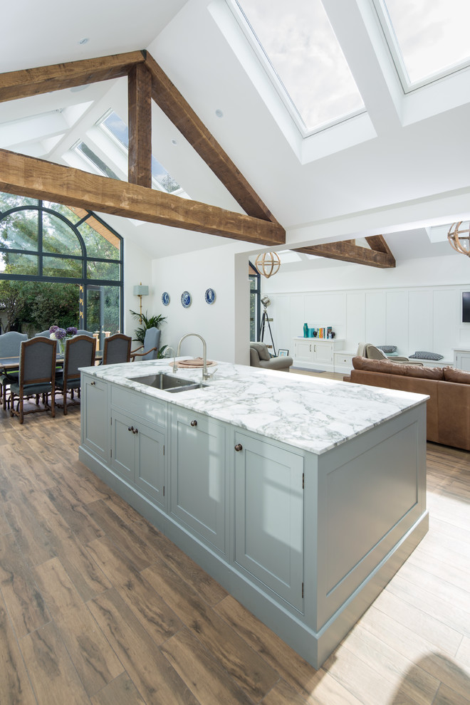 Inspiration for a large arts and crafts single-wall open plan kitchen in Dublin with glass-front cabinets and with island.