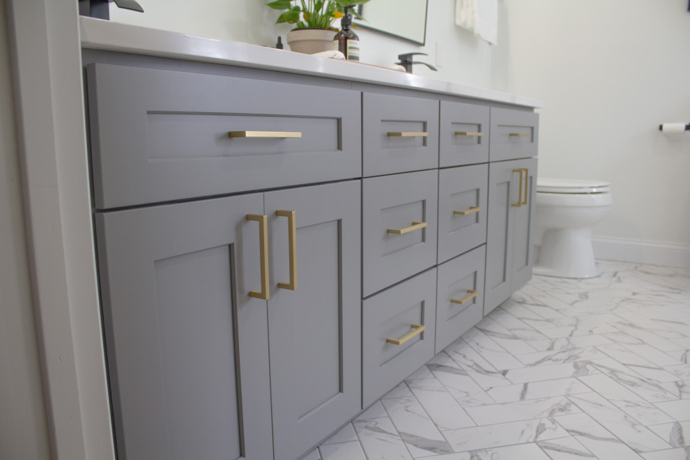 This is an example of a transitional master bathroom in Columbus with a freestanding tub, grey walls, an undermount sink, a hinged shower door, white benchtops, a double vanity and a built-in vanity.