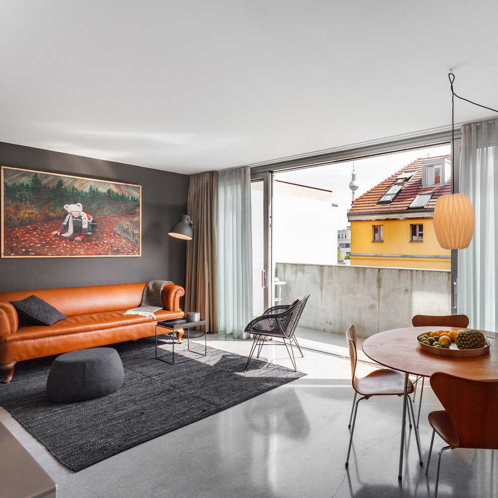 Photo of a mid-sized midcentury formal open concept living room in Hamburg with grey walls, concrete floors, grey floor, no fireplace and no tv.