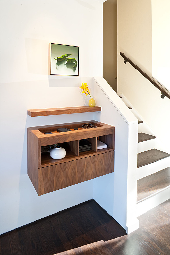 Design ideas for a midcentury entryway in San Francisco with white walls and dark hardwood floors.