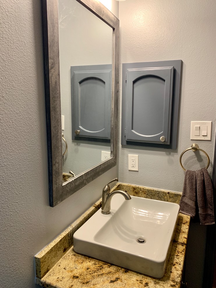 Design ideas for a mid-sized modern 3/4 bathroom in Austin with raised-panel cabinets, grey cabinets, an open shower, a one-piece toilet, gray tile, ceramic tile, grey walls, porcelain floors, a drop-in sink, granite benchtops, multi-coloured floor, a shower curtain and beige benchtops.