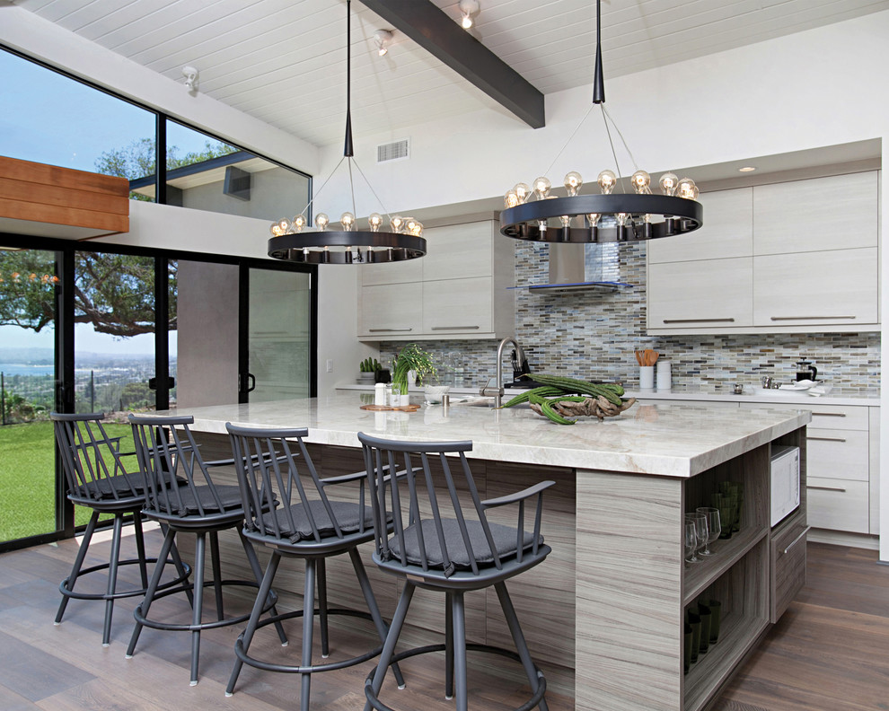 Midcentury kitchen in San Diego with flat-panel cabinets, light wood cabinets, multi-coloured splashback, mosaic tile splashback, medium hardwood floors and with island.
